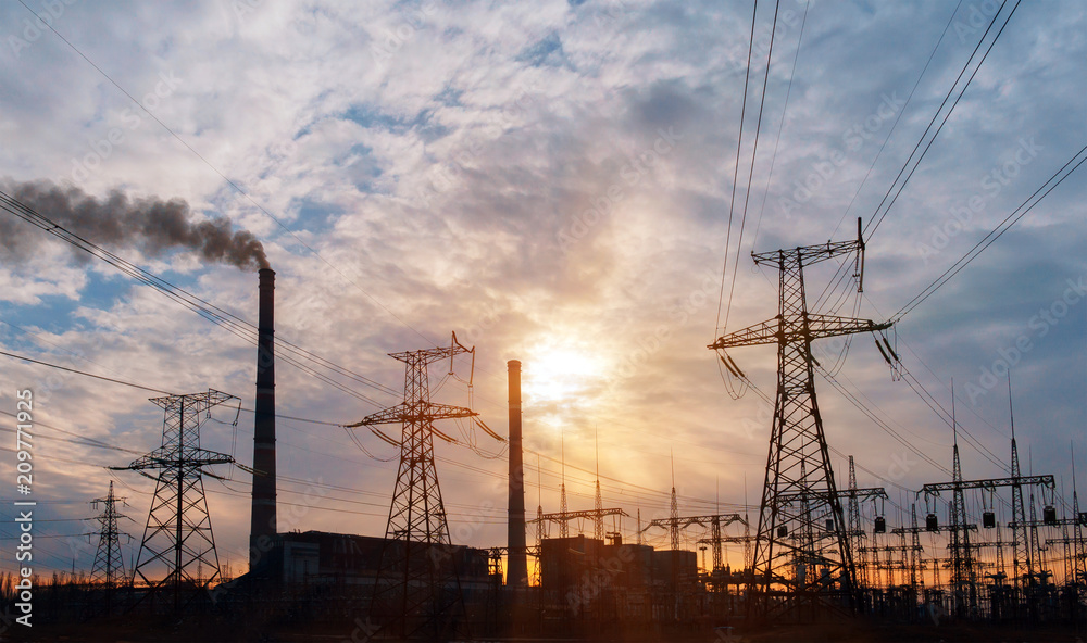 Fototapeta premium distribution electric substation with power lines and transformers, at sunset