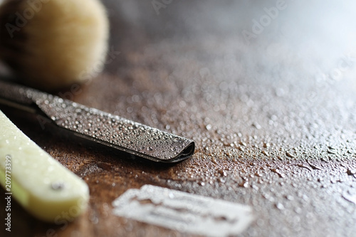 Shaving accessories on a wooden background