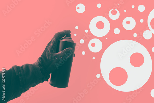 Duotone image of graffiti artist holding color spray can