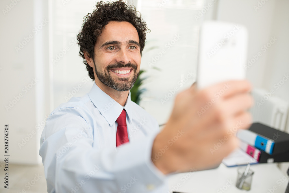 Smiling businessman taking a selfie pic of himself Smiling businessman taking a selfie pic of himself