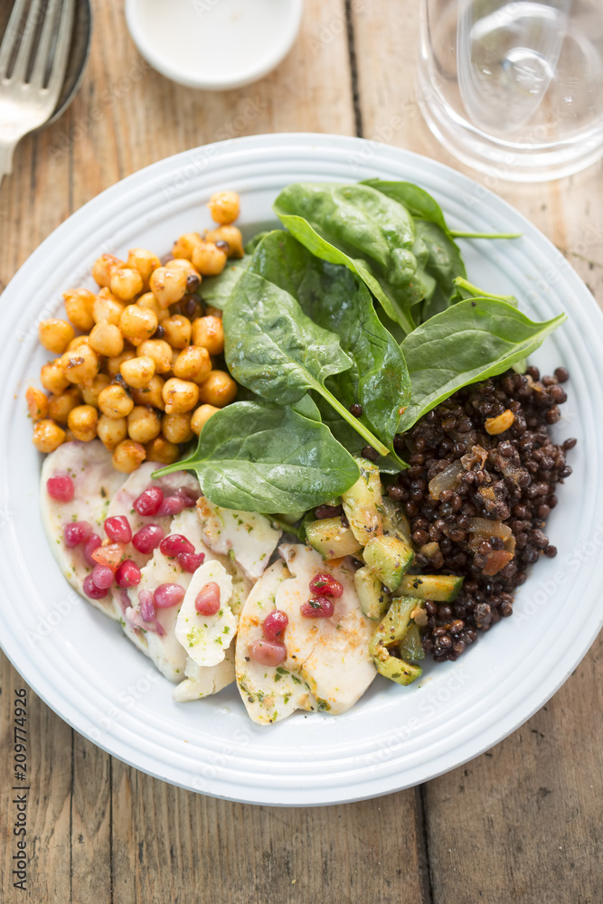Persian salad with beluga lentils in red onion chutney, cucumber, tomato, onion, chickpeas, baby leaf spinach and pomegranate seeds. Persian salad with beluga lentils in red onion chutney, cucumber, tomato, onion, chickpeas, baby leaf spinach and pomegranate seeds.