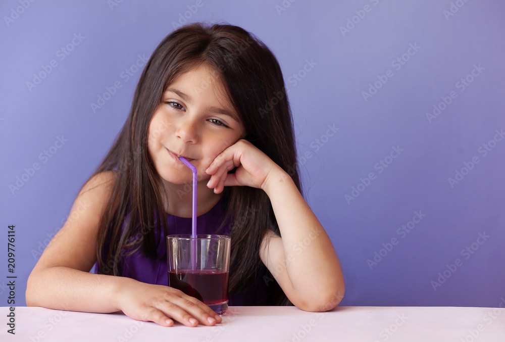 Cute little brunette girl drinking fresh juice Cute little brunette girl drinking fresh juice