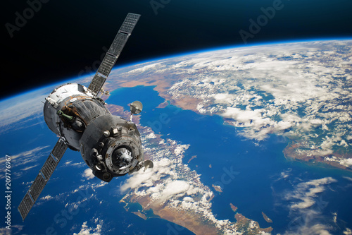 Spaceship piloted by astronauts in the orbit of planet Earth land and ocean, peninsula. Elements of this image furnished by NASA. photo