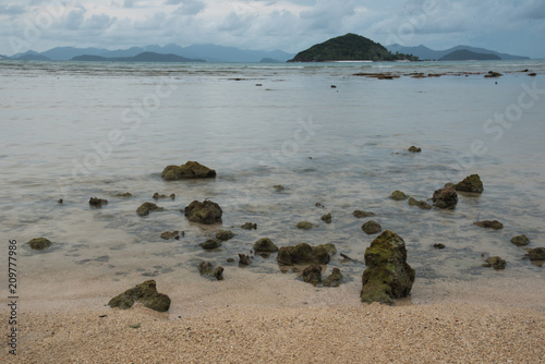Rocks on the beach with the sea on the background