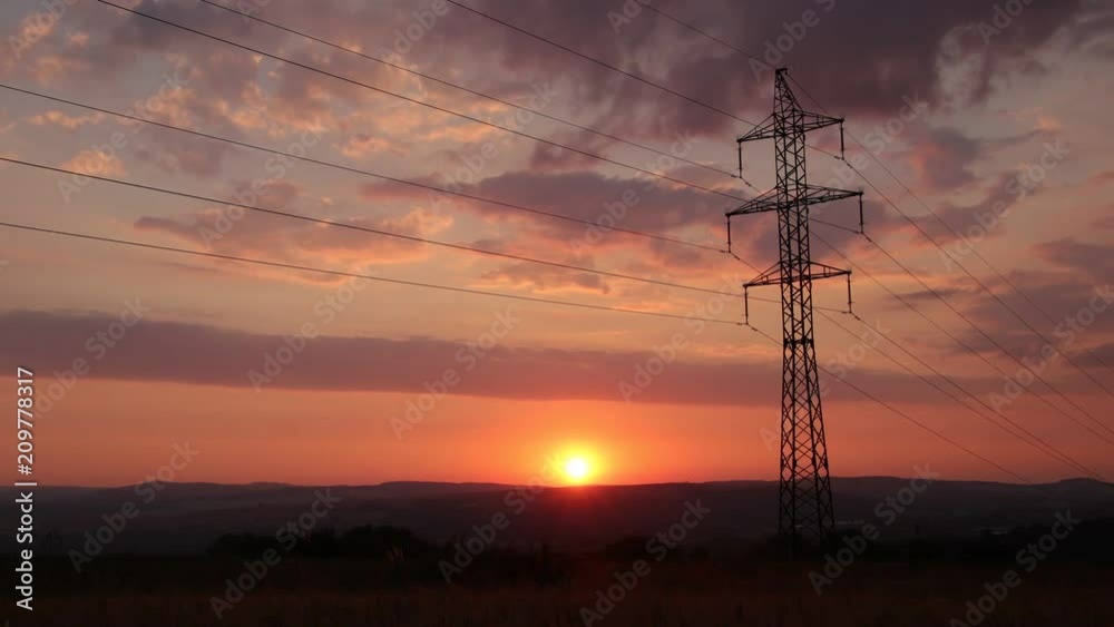 Sunset behind electricity pylon 