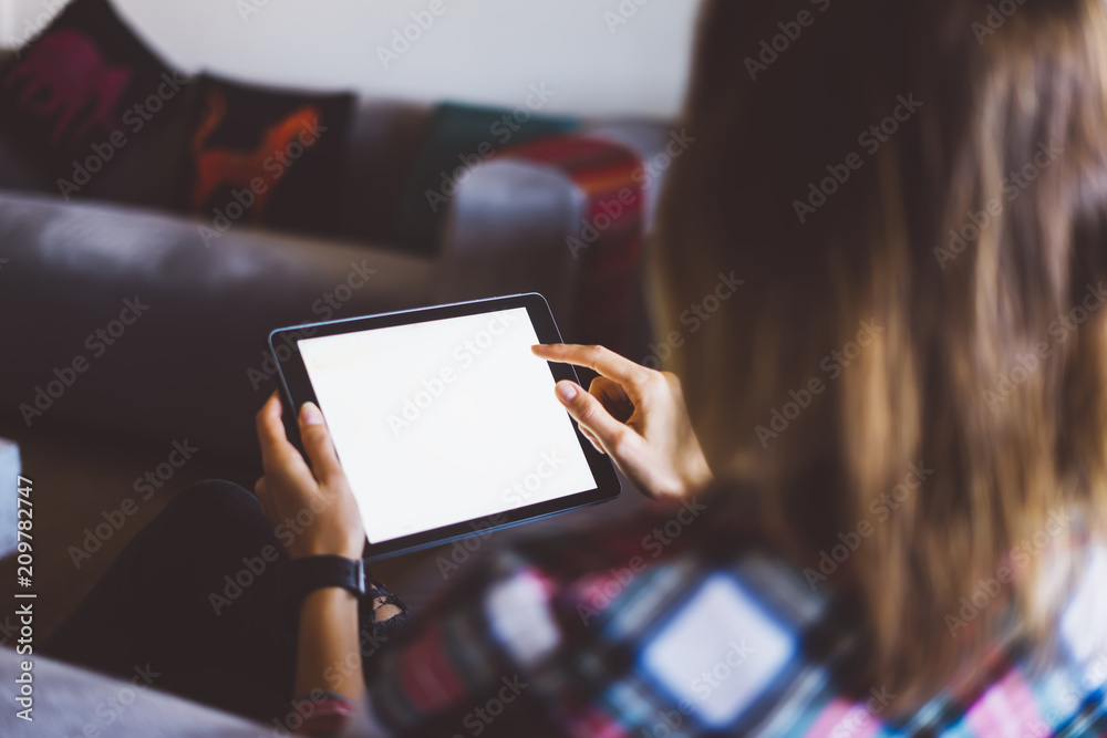 Hipster girl using tablet technology in home, blogger girl person holding computer with blank screen on background bokeh, female hands texting on relax holiday, mockup templates gadget