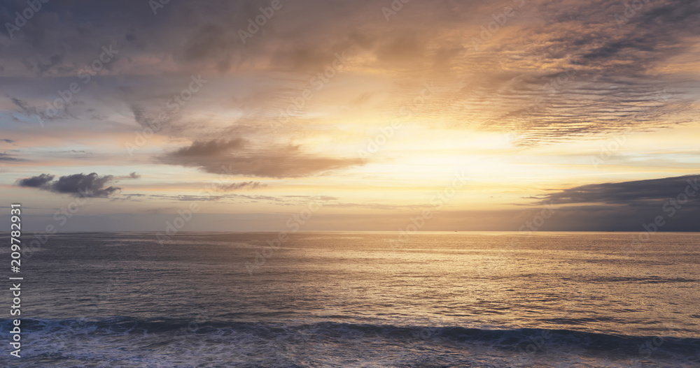 Sunlight sunset on horizon ocean on background seascape atmosphere rays sunrise. Relax view waves sea on evening sand beach, sun light flare nature evening outdoor vacation concept