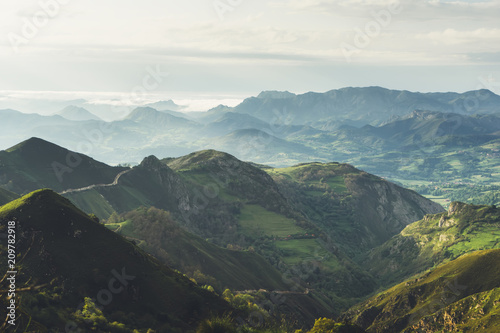 morning mist in the mountain peaks on natural landscape. Green valley on background foggy dramatic sky. Panorama horizon perspective view of scenery hills Northern Spain mountain tops © A_B_C