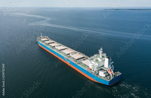 Aerial view of cargo ship floating in the sea