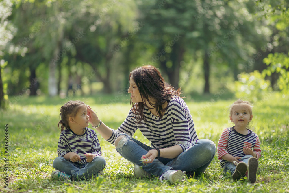 Fototapeta premium Mother and daughter having fun and playing together in the field.