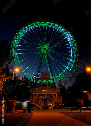 Amusement park at night - big ferris wheel with illumination