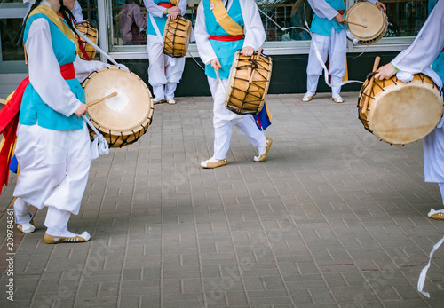 Blured picture of Musicians play on a Korean traditional percussion musical instrument Janggu. Samul nori or Pungmul on the festival of Korean culture