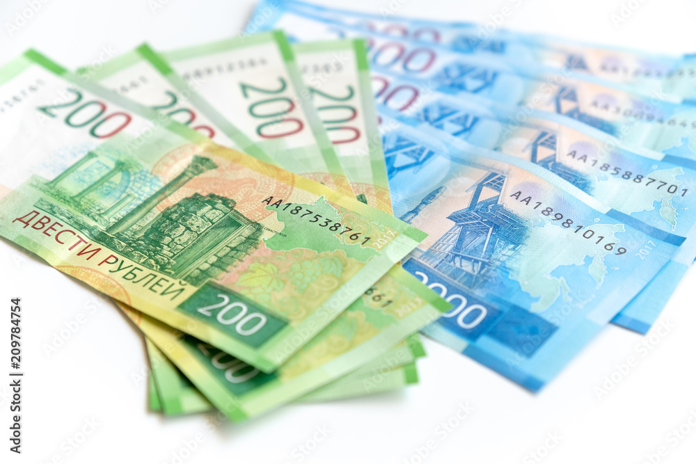 new Russian banknotes in denominations of 200 and 2000 rubles close-up on a white background, top view new Russian banknotes in denominations of 200 and 2000 rubles close-up on a white background, top view