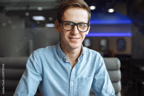Εκτύπωση καμβά Portrait of a handsome young man, hipster posing with a serious look in glasses,
