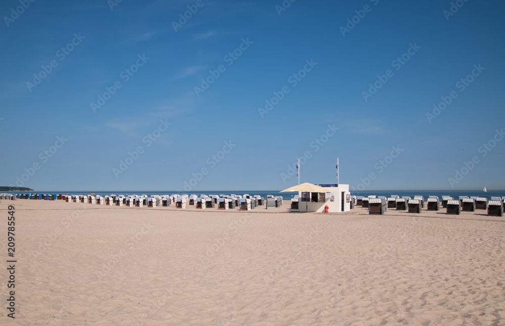 Rows of chair huts and snack bar on beach in Warnemund, Germany Rows of chair huts and snack bar on beach in Warnemund, Germany