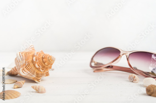 Big shell and sunglasses like summer vactions concept with copy space photo