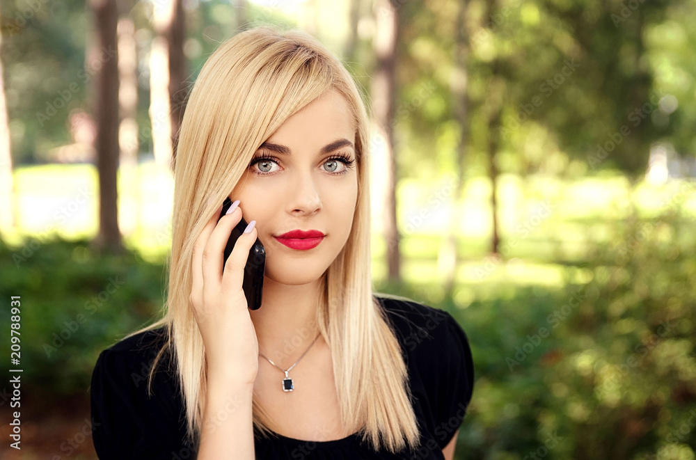 Young woman talking on mobile phone outdoor Young woman talking on mobile phone outdoor
