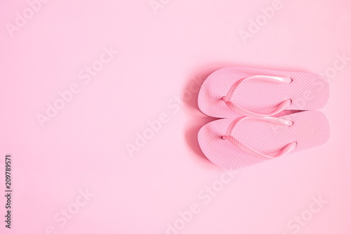 Pink beach flip flop on pink background. Summer concept. Flat lay, top view, copy space