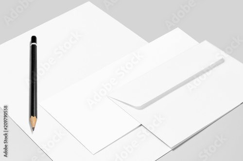 Blank stationery: sheet of paper, pencil, and two envelopes 