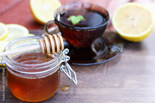 Fresh honey with a cup of black tea