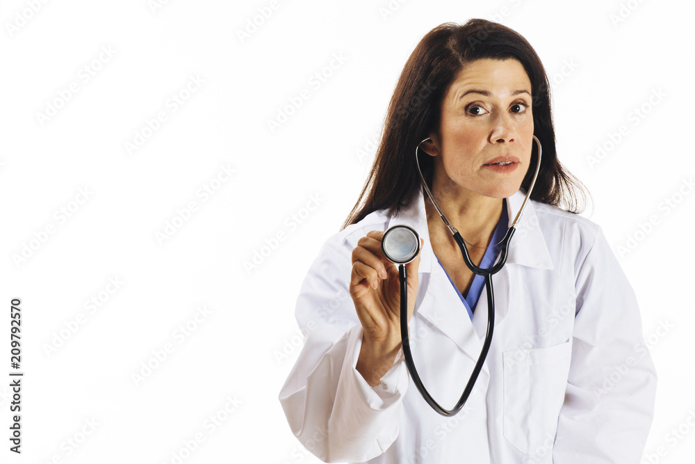 Portrait of a serious female doctor holding stethoscope and looking at camera, isolated on white studio background Portrait of a serious female doctor holding stethoscope and looking at camera, isolated on white studio background