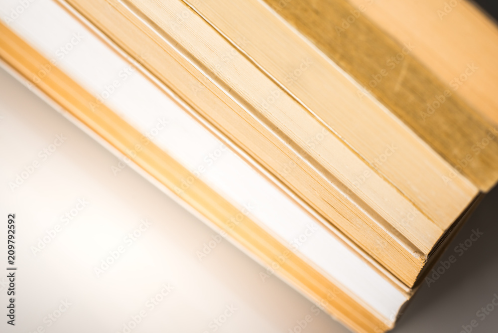Many stacked books with white background with space Many stacked books with white background with space