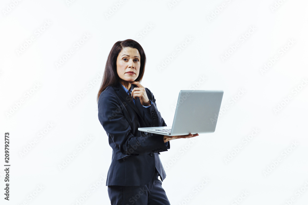 Portrait of a standing businesswoman holding laptop and looking at camera, isolated on white Portrait of a standing businesswoman holding laptop and looking at camera, isolated on white