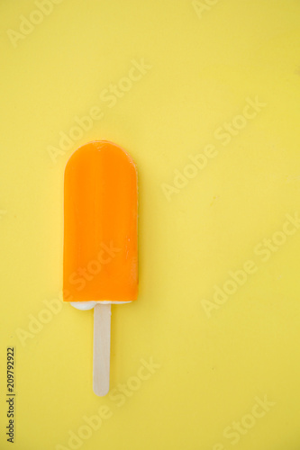 Popsicle with fresh orange on a table