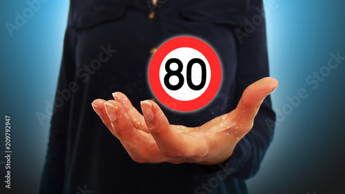 Businesswoman on blurred background holding hand speed limits