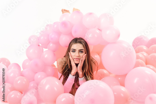 Pretty girl with long hair posing with balloons. Party mood. Gorgeous woman with colorful balloons. Celebration concept. Preparation to birthday party. Trendy woman posing in pink balloons.