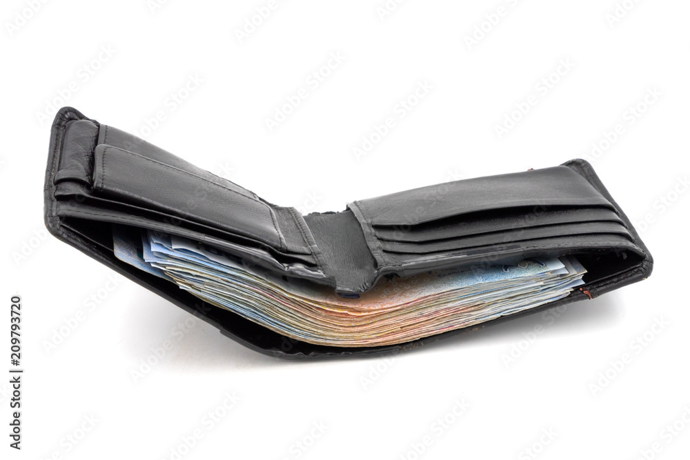 Many banknotes in black wallet on white background Many banknotes in black wallet on white background