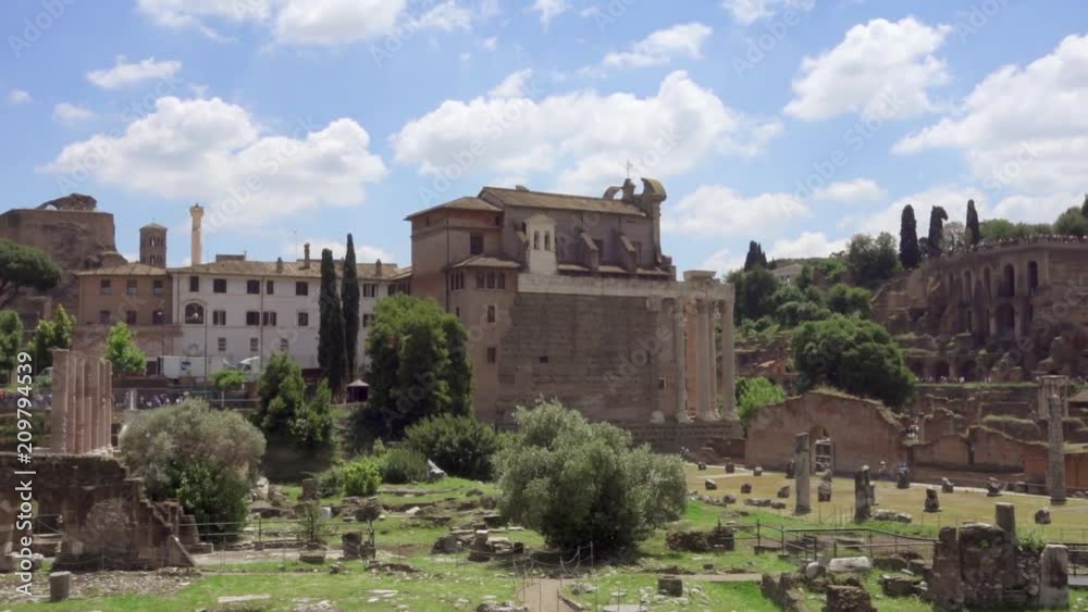 Exterior of ancient ruins Forum Romanum. Roman forum in center of Rome, Italy. Historical european architecture. Columns and stones of old monument in slow motion. Unrecognizable people in distance Exterior of ancient ruins Forum Romanum. Roman forum in center of Rome, Italy. Historical european architecture. Columns and stones of old monument in slow motion. Unrecognizable people in distance
