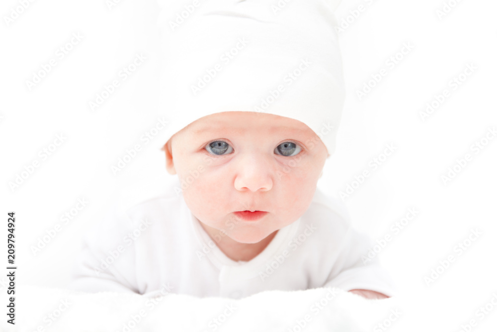 A cute little baby is looking into the camera A cute little baby is looking into the camera