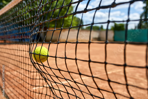Yellow tennis ball in net © Andriy Bezuglov
