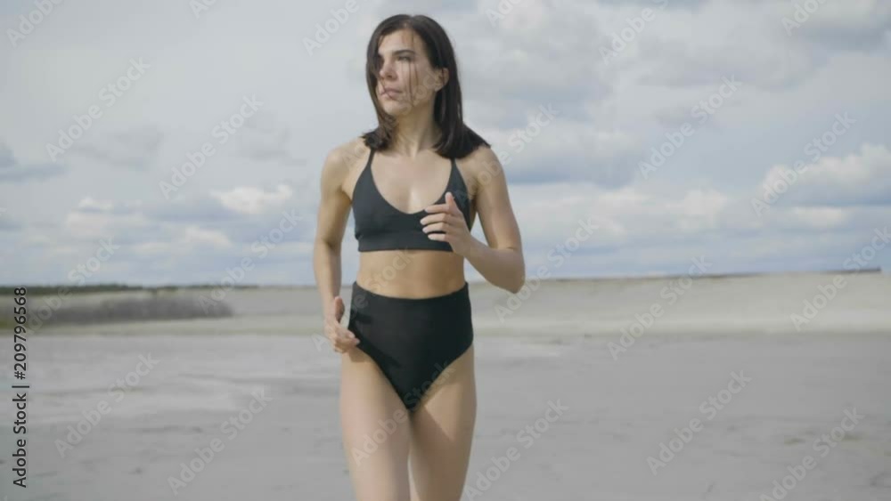 Brunette is training on the beach Brunette is training on the beach