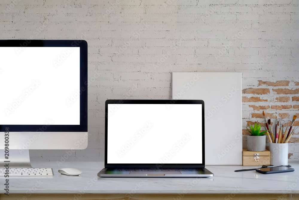 Mockup blank screen desktop and laptop computer on desk. workspace front view Mockup blank screen desktop and laptop computer on desk. workspace front view