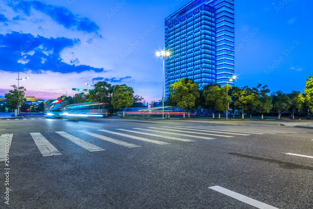Obraz premium empty road with zebra crossing and skyscrapers in modern city.