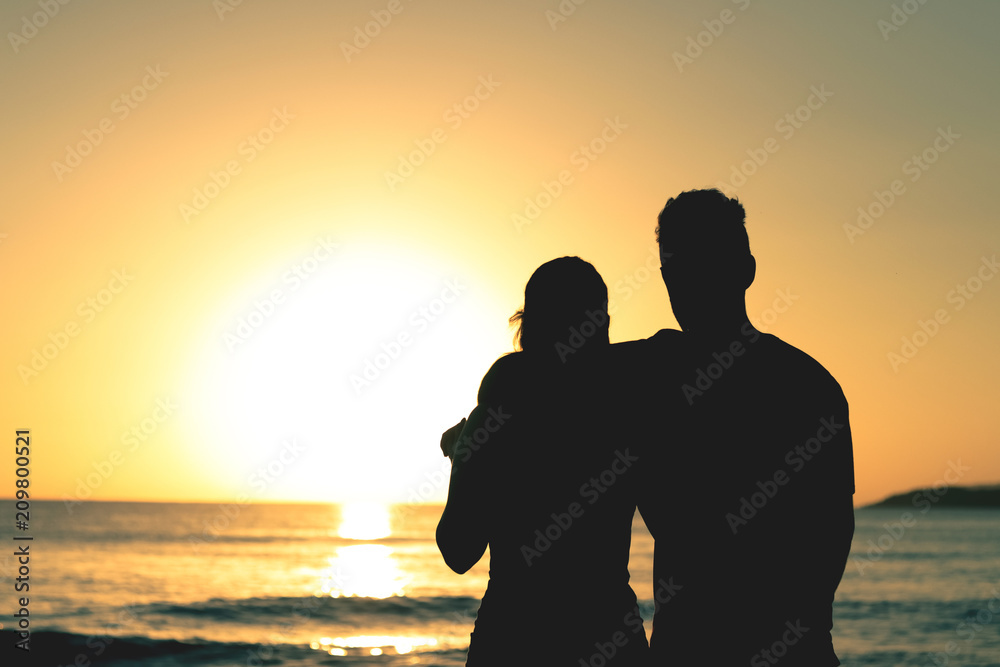 Couple waiting the sunrise at the beach Couple waiting the sunrise at the beach