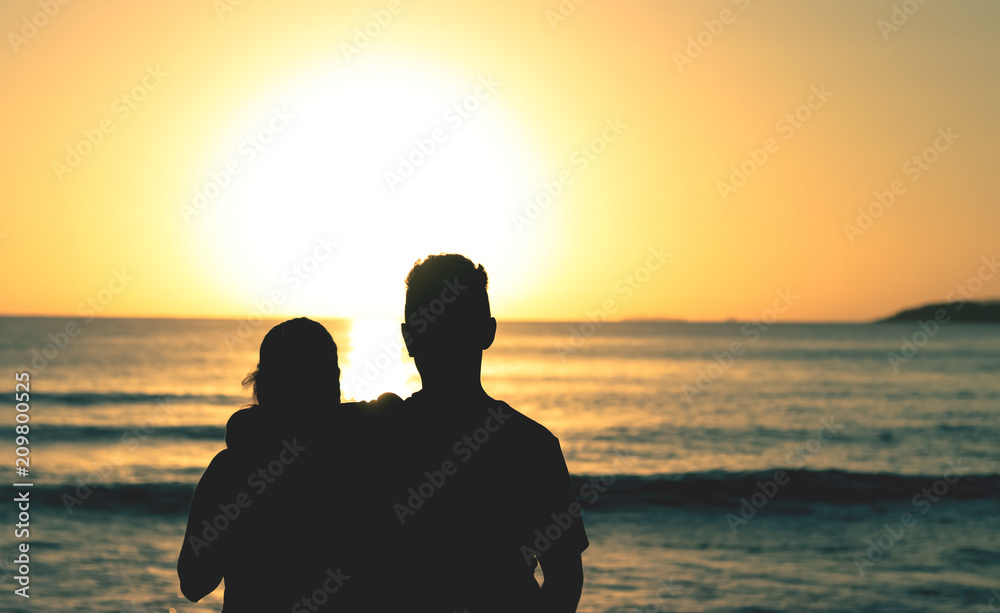 Couple waiting the sunrise at the beach