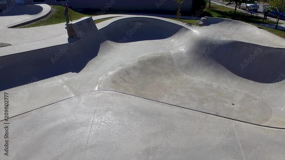Aerial shot of boys riding scooters at the skate park