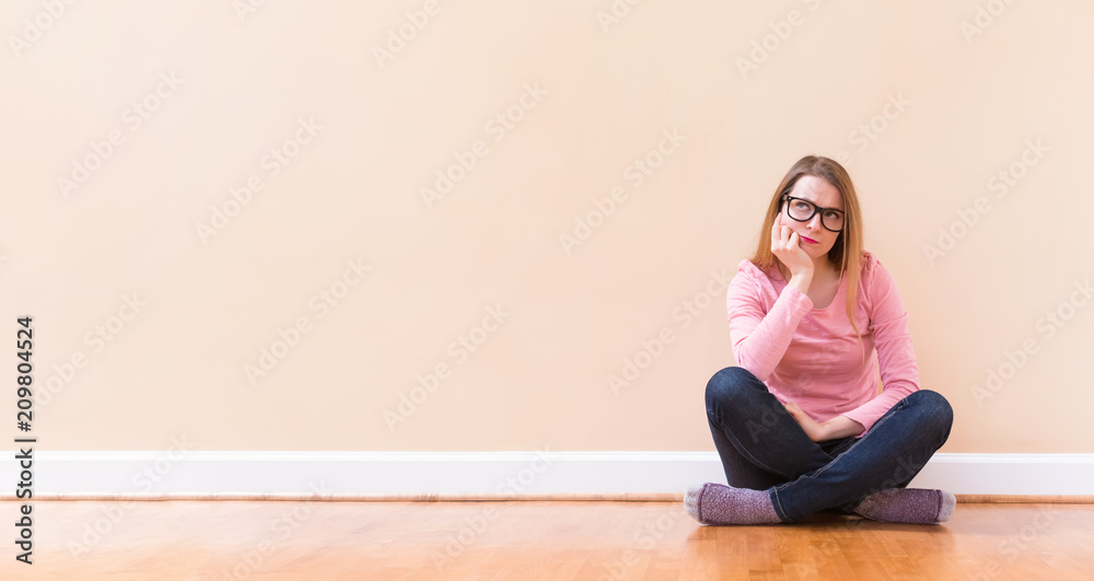 Young woman thinking about something in a big room Young woman thinking about something in a big room