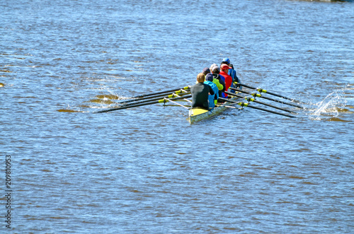 A team of rowers in a sports boat.