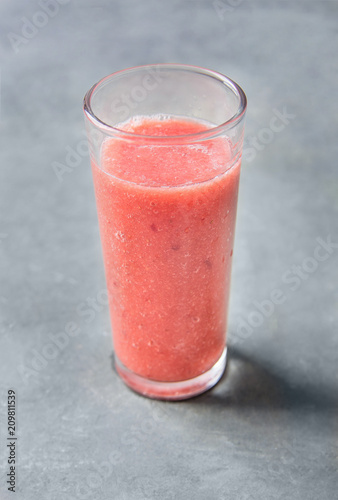 Glass with Fresh Strawberries Banana Smoothie. Dark Concrete Stone Background. Healthy Drink Detox Summer Refreshment Vitamins. Copy Space