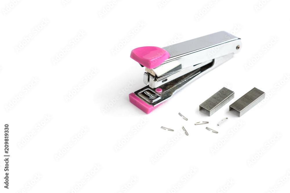 Pink stapler and brackets isolated on a white background. Pink stapler and brackets isolated on a white background.