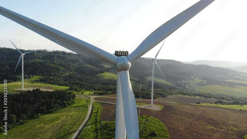 aerial view of clean and renewable wind power farm in motion konverting kinetic energy modern electric industry environmental protection innovation ecosystem electricity generator wind turbines