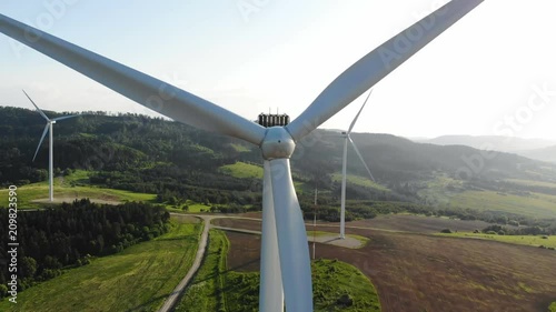 aerial view of clean and renewable wind power farm in motion konverting kinetic energy modern electric industry environmental protection innovation ecosystem electricity generator wind turbines photo