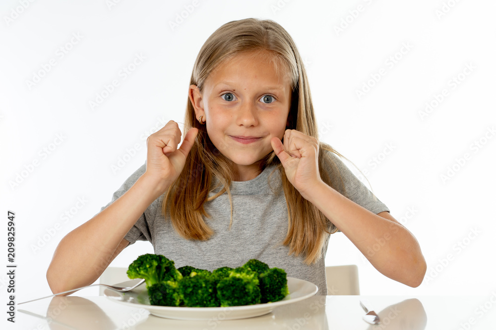 happy healthy yong girl eating her broccoli vegetables in healthy eating concept happy healthy yong girl eating her broccoli vegetables in healthy eating concept