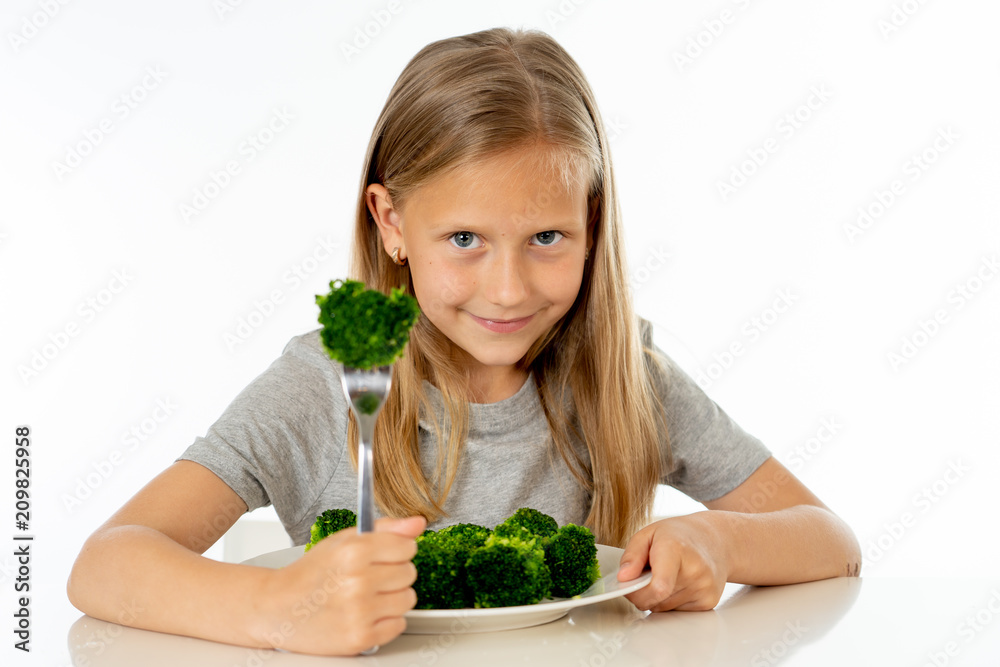 happy healthy yong girl eating her broccoli vegetables in healthy eating concept happy healthy yong girl eating her broccoli vegetables in healthy eating concept