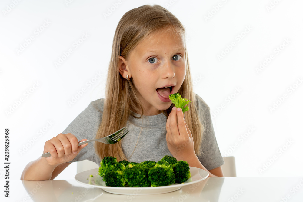happy healthy yong girl eating her broccoli vegetables in healthy eating concept happy healthy yong girl eating her broccoli vegetables in healthy eating concept