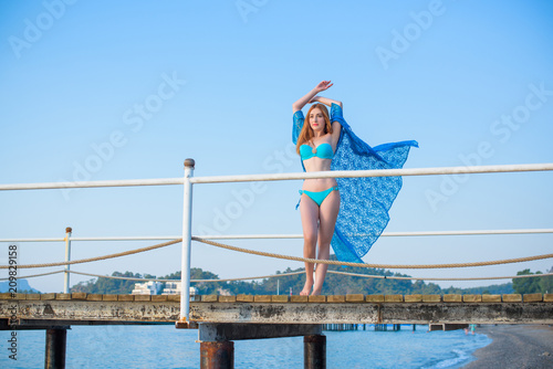 Luxury Resort. Woman Relaxing at sea. Beautiful Happy Healthy Female Model Enjoying Summer Travel Vacation, Looking At Sea View. Summertime Recreation, Relax And Spa Concept  © T.Den_Team